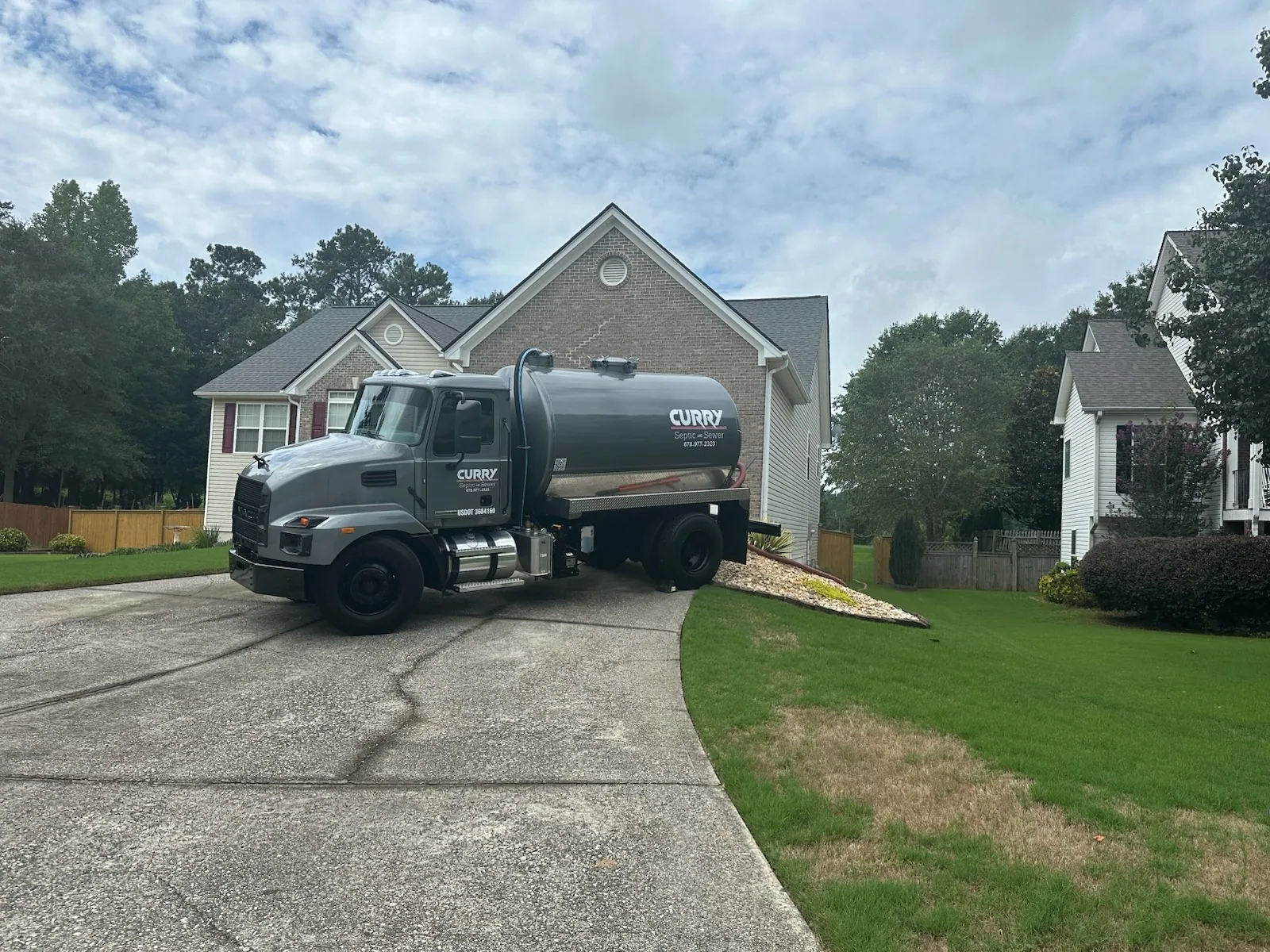 Curry septic service truck residential driveway